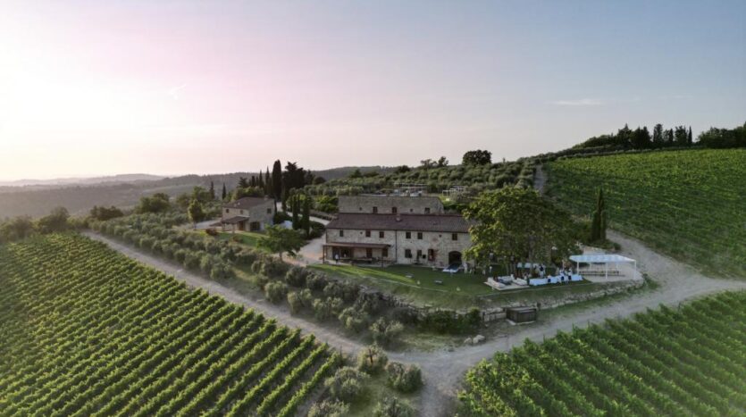 Aerial view of luxury villa in Chianti surrounded by vineyards and Tuscan countryside
