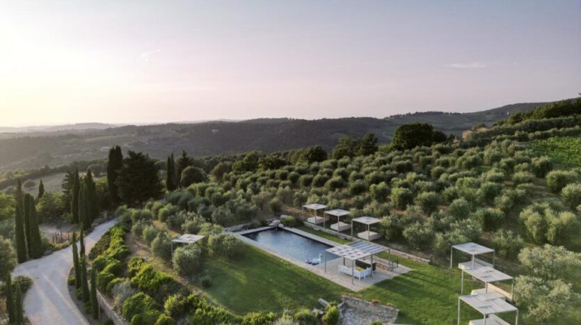 Aerial view of luxury villa in Chianti surrounded by vineyards and Tuscan countryside